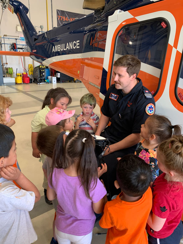 Students meet with an medic to check out an air ambulance
