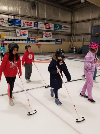 A group of four students on the curling rink